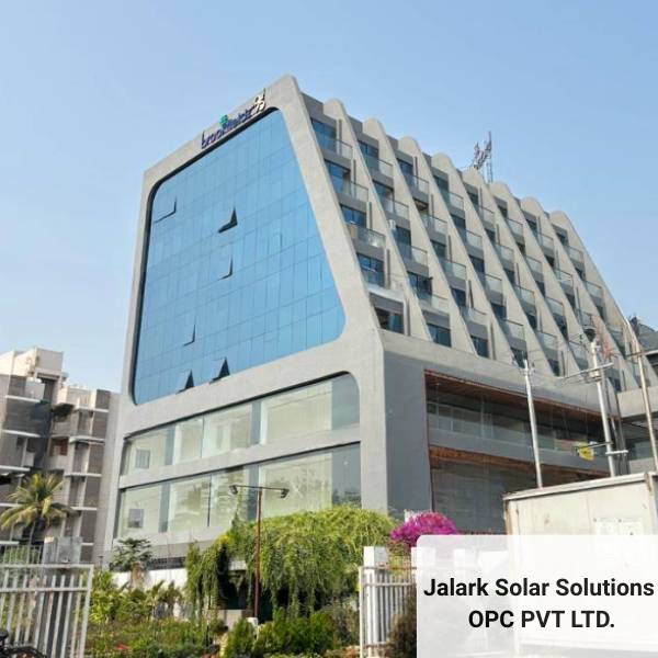 The Vadodara office location for Jalark Solar Solutions, a modern commercial building with a blue glass facade.
