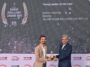 Chintan Mahida receiving the Young Leader of the Year 2025 Award on stage from a presenter at the Energy Excellence Awards.